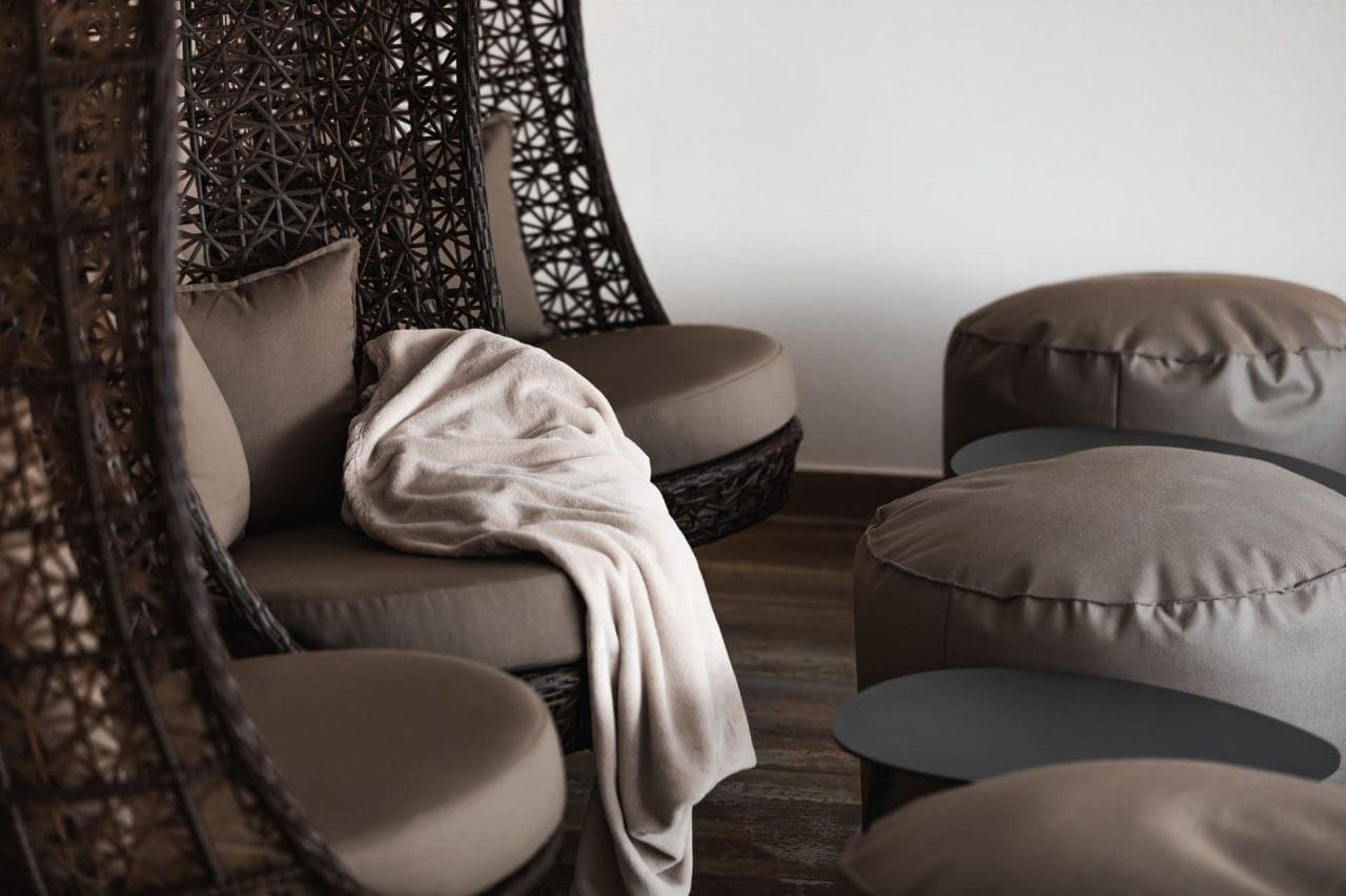 Gemütliche Sitzecke mit Decke und Poufs.